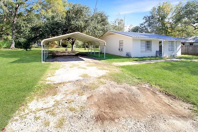 view of front of home with a front lawn and a carport