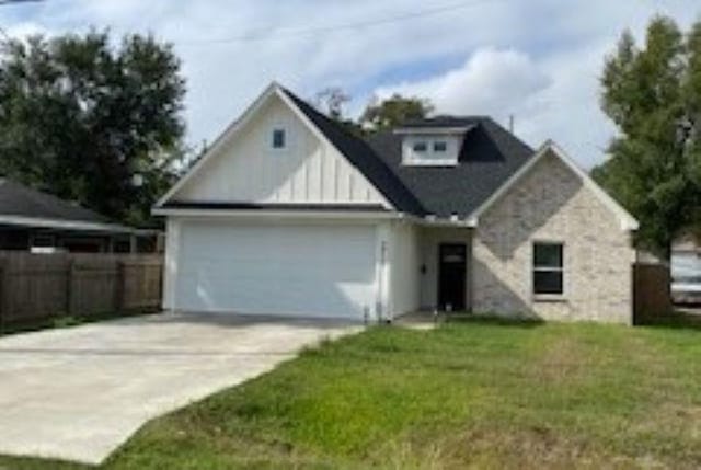 view of front of house with a garage and a front lawn