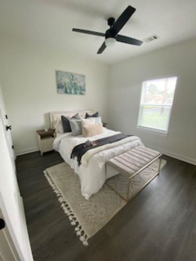 bedroom featuring ceiling fan and dark wood-type flooring