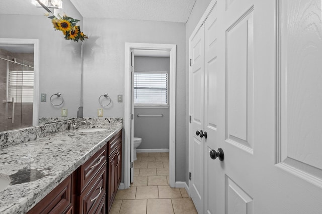 2515 Black Oak Dr, Orange, TX 77632 - bathroom with toilet, vanity, tile patterned flooring, a textured ceiling, and baseboards