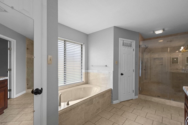 2515 Black Oak Dr, Orange, TX 77632 - bathroom with vanity, a shower stall, a garden tub, and tile patterned floors