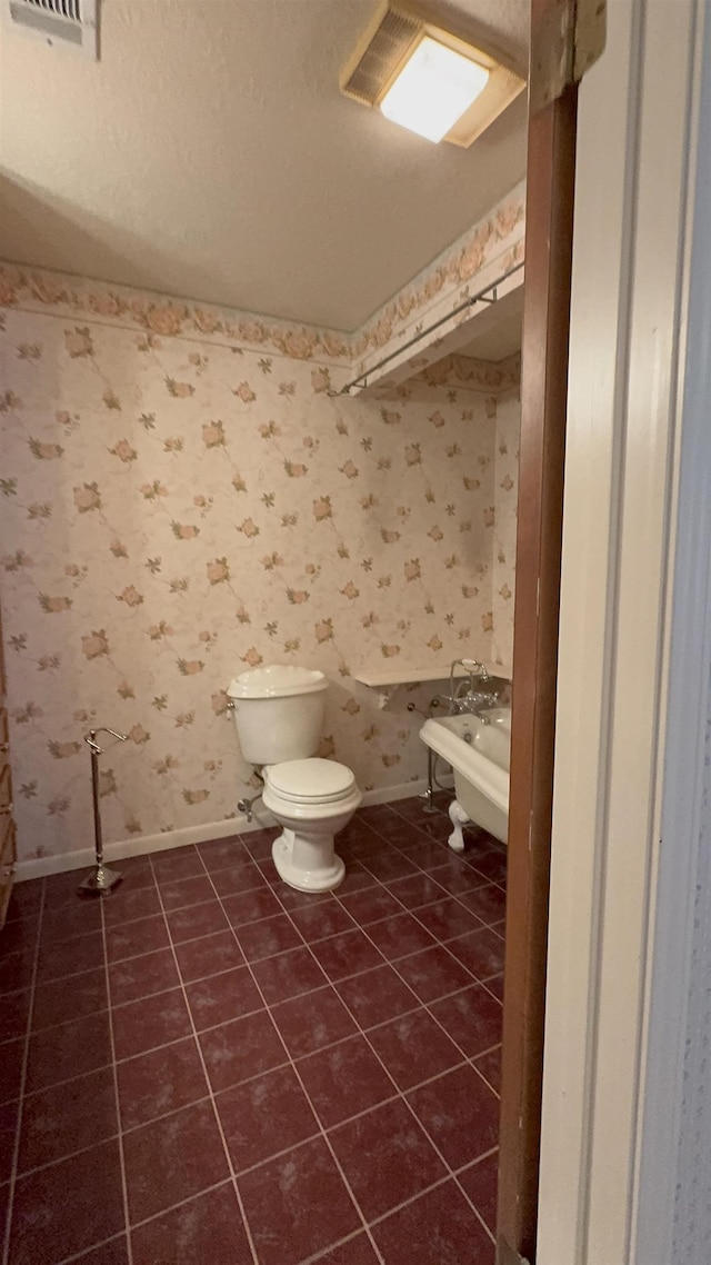 bathroom with tile patterned flooring and toilet