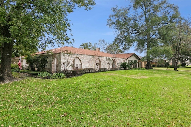5990 Pinkstaff Ln, Beaumont, TX 77706 - view of side of property with a lawn, a chimney, and brick siding