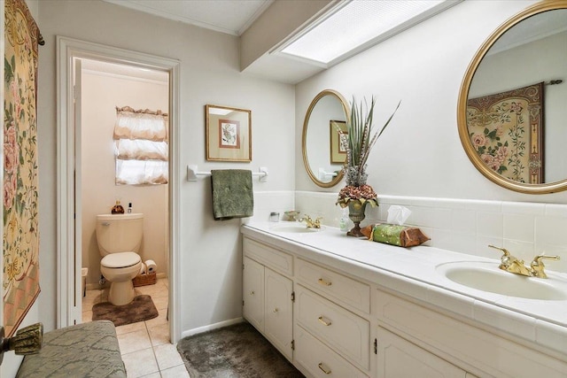 5990 Pinkstaff Ln, Beaumont, TX 77706 - bathroom with double vanity, tile patterned flooring, toilet, and crown molding
