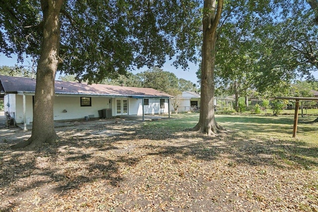 view of yard featuring cooling unit and french doors