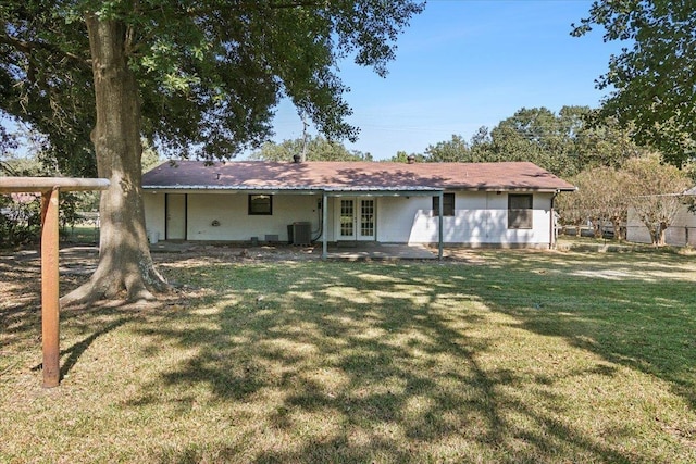 back of house with french doors, central AC unit, and a lawn