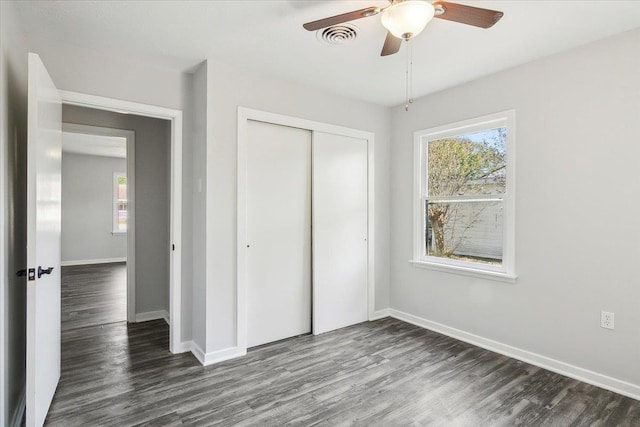 unfurnished bedroom featuring a closet, ceiling fan, and dark hardwood / wood-style floors