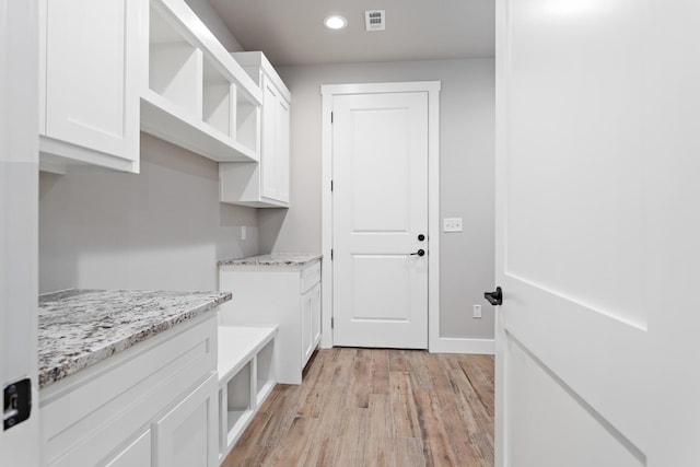 washroom with light wood-type flooring