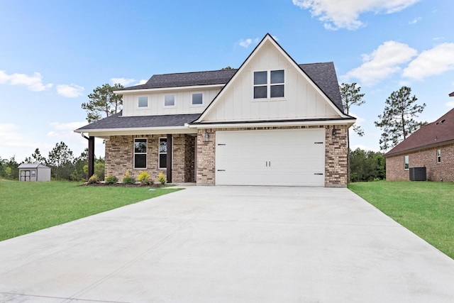 view of front of house featuring central AC, a storage unit, a front yard, and a garage