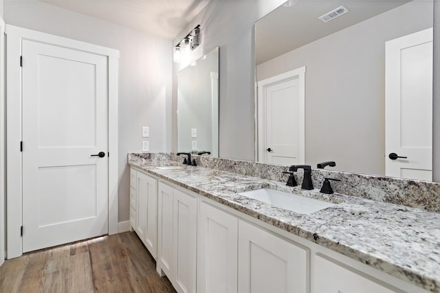 bathroom with vanity and hardwood / wood-style flooring