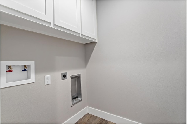 washroom with electric dryer hookup, cabinets, dark hardwood / wood-style floors, and washer hookup