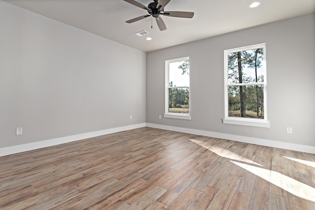 empty room featuring ceiling fan and light hardwood / wood-style flooring