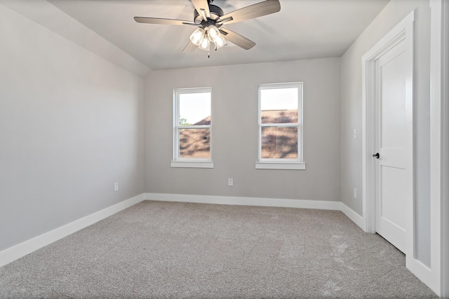 spare room featuring carpet flooring, ceiling fan, and vaulted ceiling