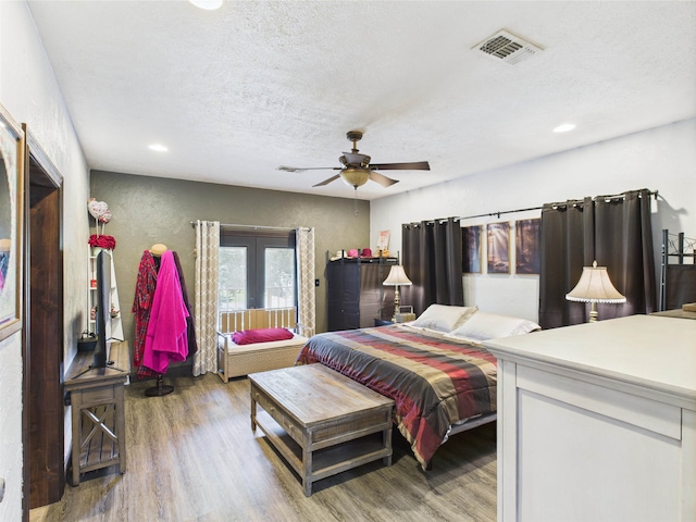 650 Sudduth Dr, Bridge City, TX 77611 - bedroom with wood finished floors, recessed lighting, a textured ceiling, french doors, and ceiling fan