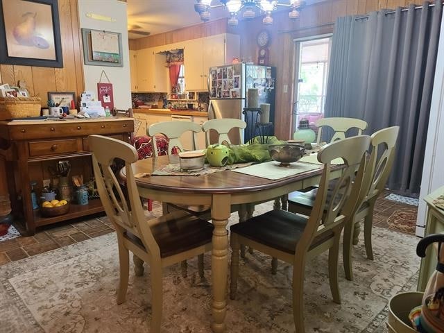 dining room with wooden walls