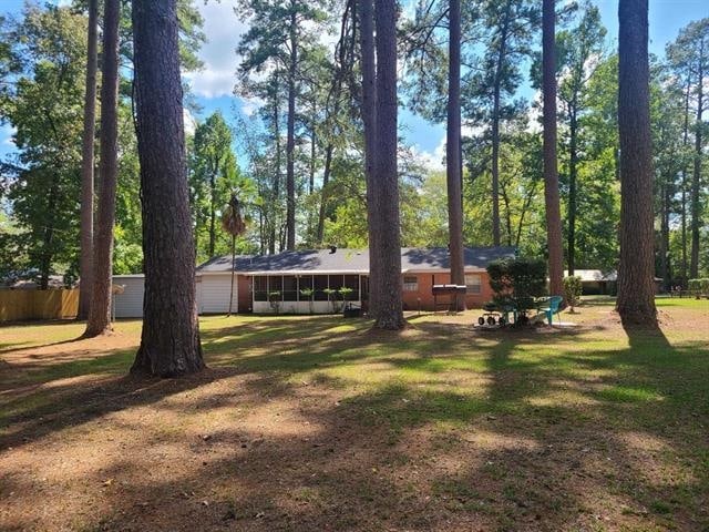 view of yard featuring a sunroom