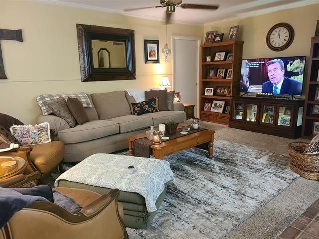 carpeted living room with ceiling fan and ornamental molding