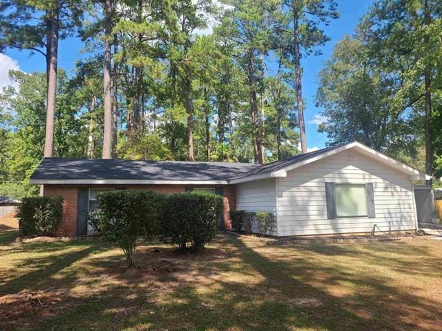 view of property exterior with a lawn