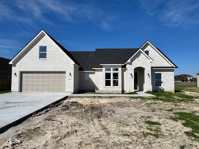 view of front facade with a garage, concrete driveway, and brick siding