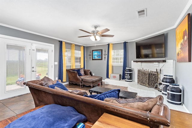 living room featuring visible vents, a ceiling fan, a wealth of natural light, and crown molding