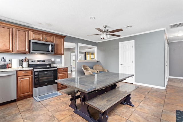 kitchen with visible vents, appliances with stainless steel finishes, brown cabinetry, and ornamental molding