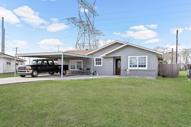 ranch-style home with brick siding, fence, a carport, driveway, and a front lawn