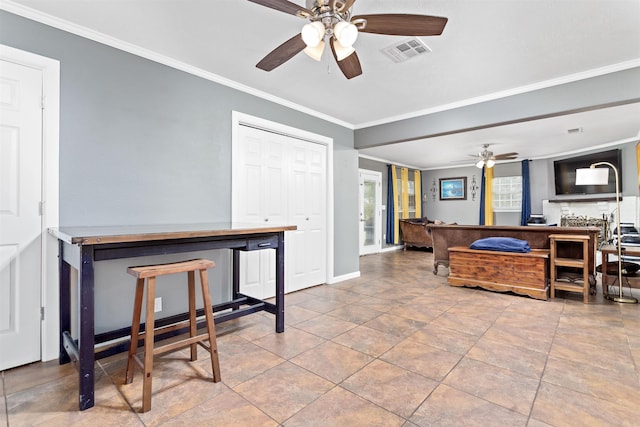 interior space featuring ceiling fan, ornamental molding, visible vents, and baseboards