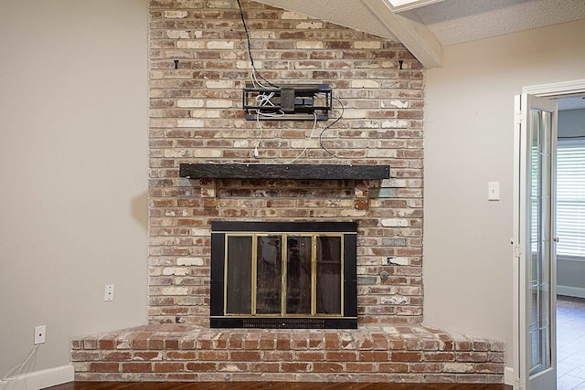 interior details with hardwood / wood-style flooring and a brick fireplace