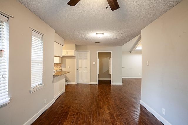 interior space with dark hardwood / wood-style floors and a textured ceiling