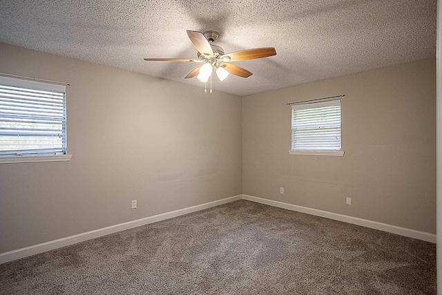 carpeted spare room with ceiling fan and a textured ceiling