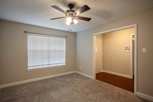 carpeted empty room featuring a textured ceiling and ceiling fan