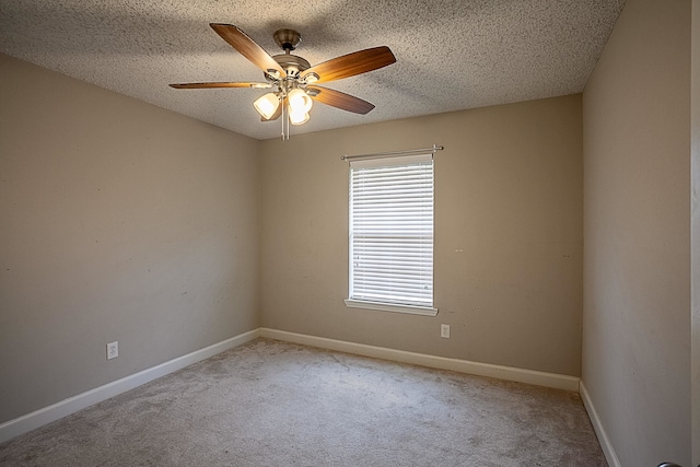 carpeted spare room featuring ceiling fan and a textured ceiling