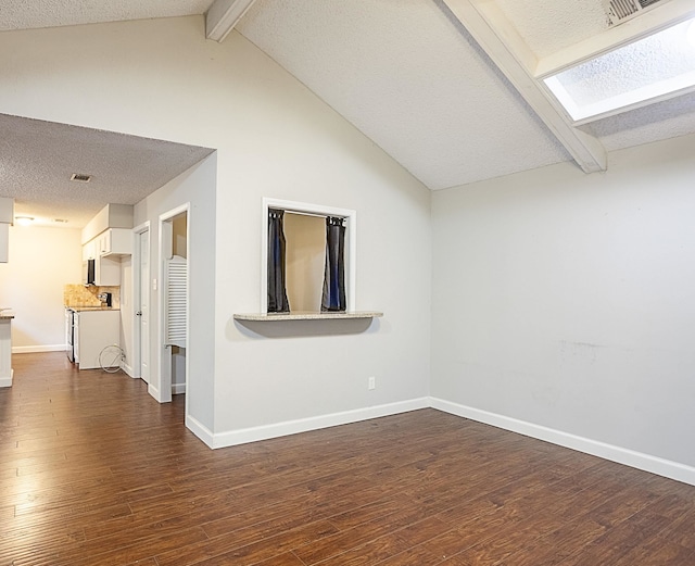 unfurnished room with a textured ceiling, lofted ceiling with beams, and dark wood-type flooring