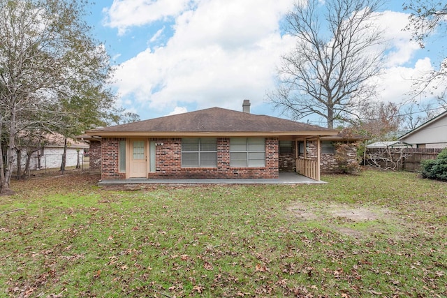 back of house featuring a yard and a patio