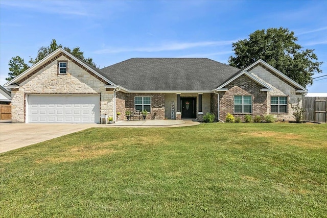 view of front of home featuring a front yard and a garage