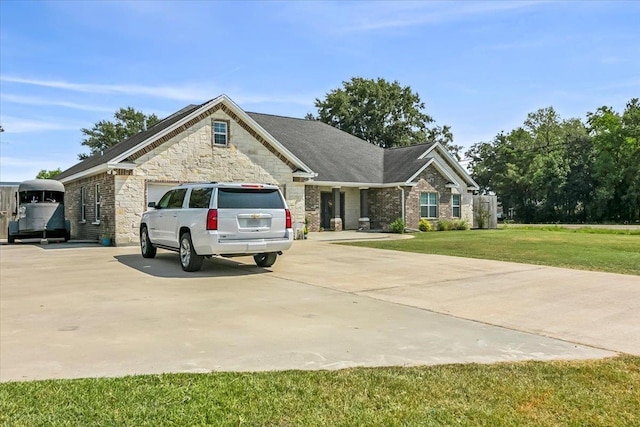 view of front of home featuring a front yard and a garage