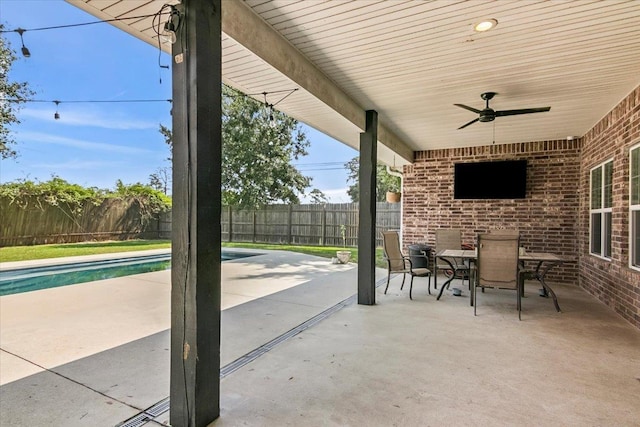 view of patio featuring a fenced in pool and ceiling fan