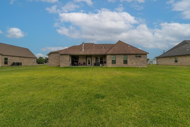 108 Colonial Estates Dr, Bridge City, TX 77611 - rear view of property featuring a lawn and brick siding