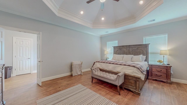 108 Colonial Estates Dr, Bridge City, TX 77611 - bedroom featuring light wood finished floors, baseboards, ornamental molding, a ceiling fan, and a tray ceiling