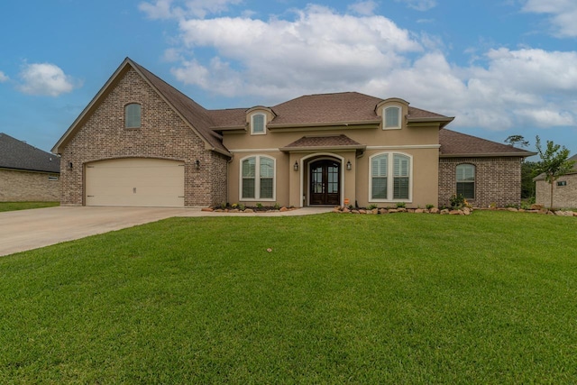 108 Colonial Estates Dr, Bridge City, TX 77611 - french country home with french doors, driveway, a front lawn, a shingled roof, and brick siding