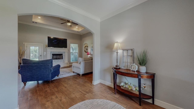 108 Colonial Estates Dr, Bridge City, TX 77611 - living area with wood finished floors, ornamental molding, ceiling fan, arched walkways, and baseboards