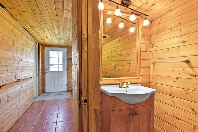 bathroom with vanity, tile patterned floors, wood walls, and wood ceiling