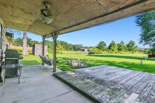 view of patio featuring a grill, ceiling fan, and a deck