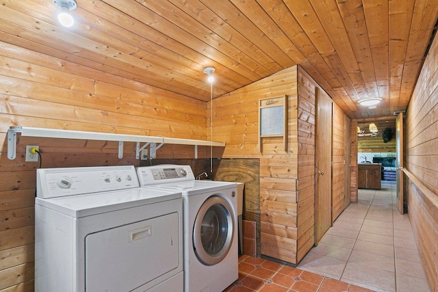 washroom featuring independent washer and dryer, wooden ceiling, and wood walls