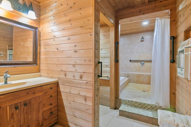 bathroom with tile patterned flooring, vanity, curtained shower, and wooden walls