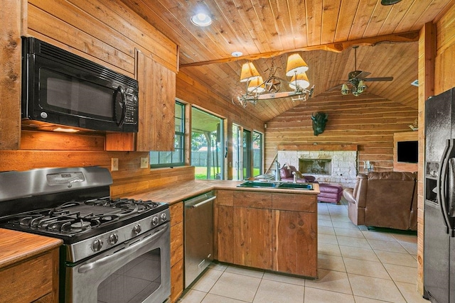 kitchen featuring black appliances, kitchen peninsula, wooden walls, light tile patterned floors, and wood ceiling