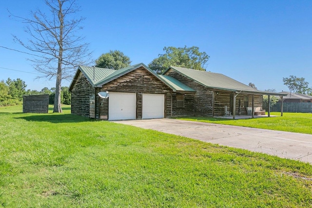 cabin featuring a front yard and a garage