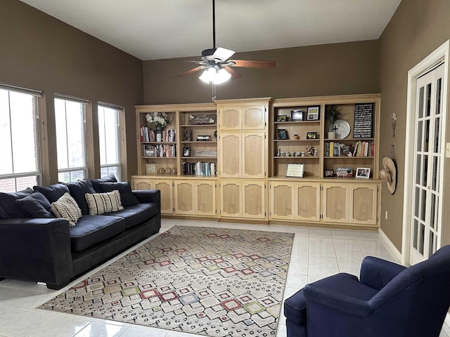 living area featuring light tile patterned flooring and ceiling fan