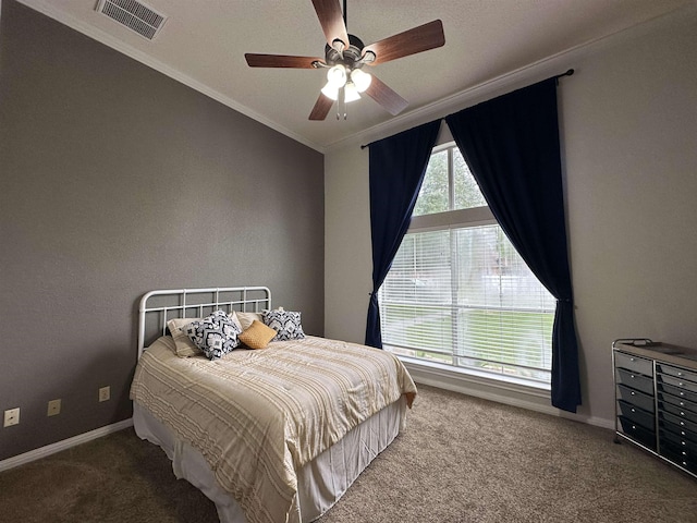bedroom featuring visible vents, crown molding, a ceiling fan, baseboards, and carpet flooring