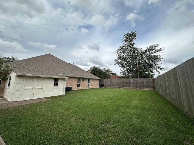 view of yard with a fenced backyard and cooling unit
